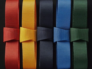 A collection of martial arts belts in various colors—red, yellow, blue, black, and green—displayed against a black background, illustrating the Martial Arts Belt Order.